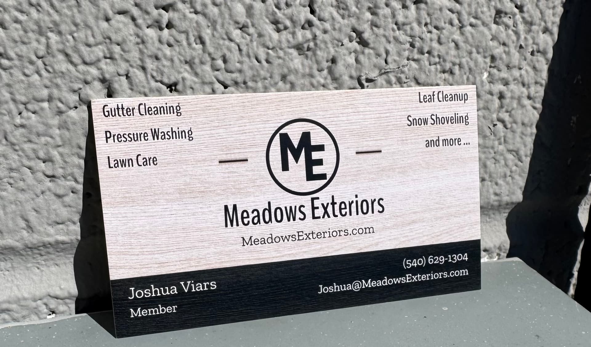 Meadows Exteriors professional business card featuring company logo, services, and Joshua Viars contact information